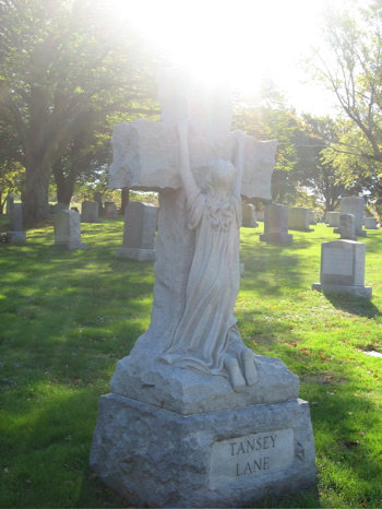 tombstone, kneeling at cross